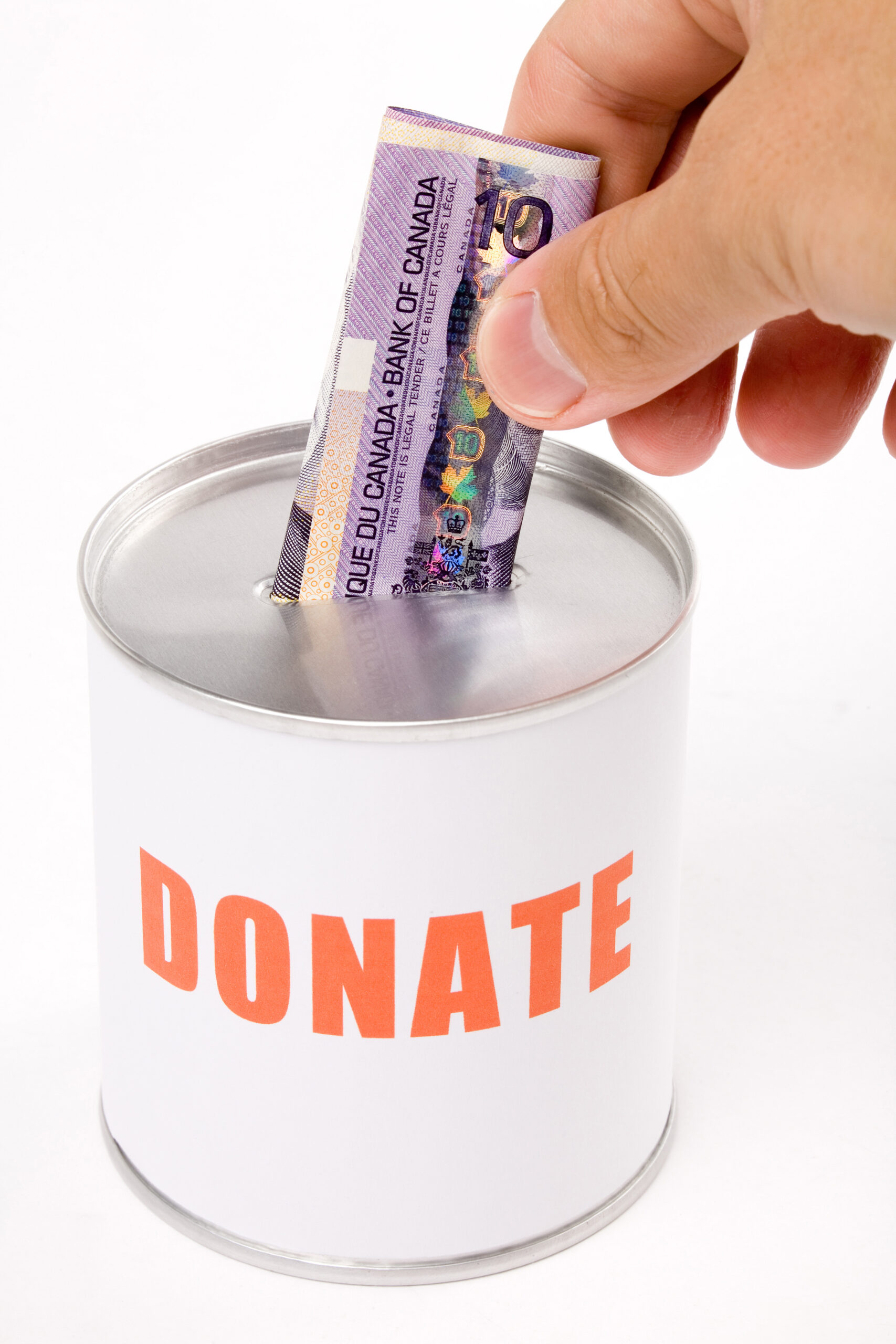 A ten dollar bill being placed into a can that reads "DONATE."