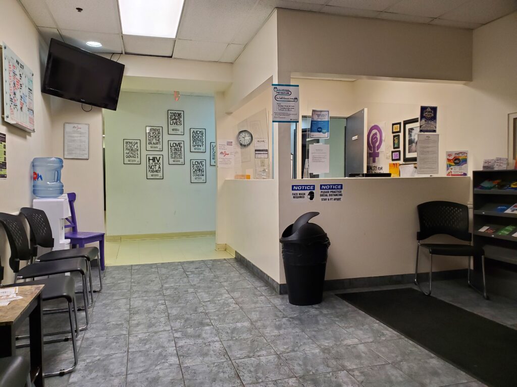A reception and waiting room with posters and fliers.