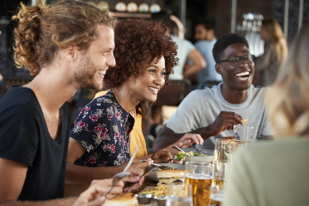 People sitting at a restaurant table enjoying dinner and socializing