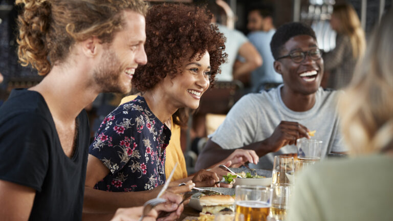 People sitting at a restaurant table enjoying dinner and socializing